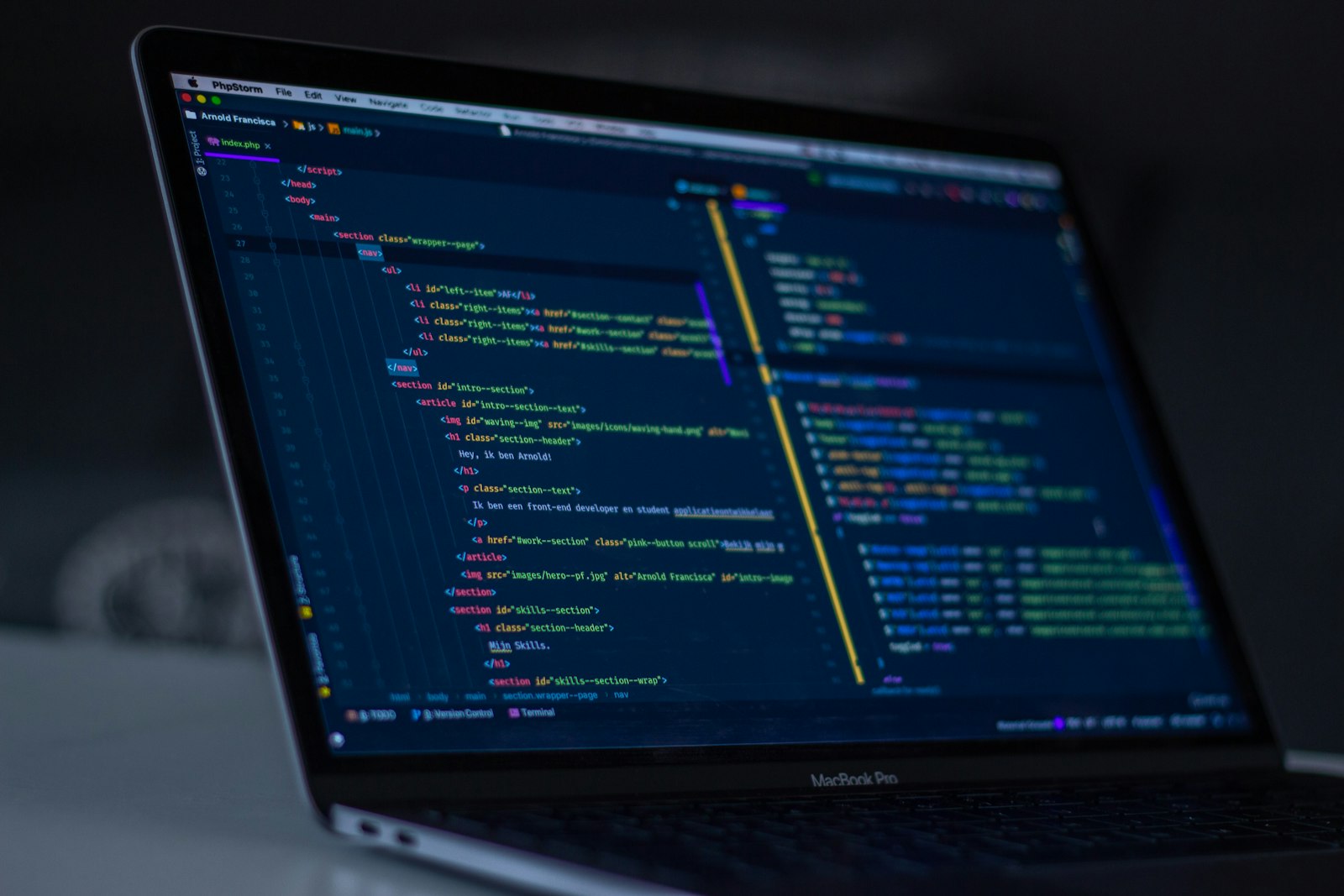 Close up of computer screen showing complex programming code, glowing syntax highlighting, dark background, shallow depth of field, software engineering concept, no people